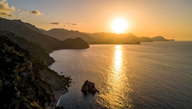 An aerial view showcases a vibrant sunset over a coastal landscape, with the sun's rays reflecting on the tranquil sea