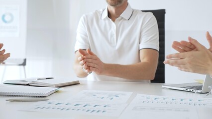 Professional business people team clapping hands, celebrating successful presentation, displaying collaborative spirit in modern office