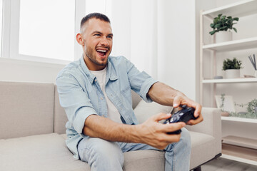 Engaged man enjoying a gaming session, showcasing authentic imperfection and soft masculinity in a cozy indoor environment, highlighting self-care and personal moments.