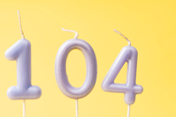 Candle number 104 - Yellow birthday