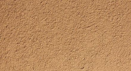 Close Up Texture of Rough Brown Stucco Wall Exterior Surface Detail