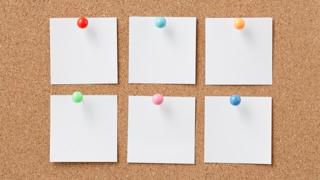 Six blank white papers pinned to a corkboard with colorful thumbtacks - Powered by Adobe