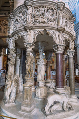 Fototapeta premium Ornate pulpit with sculpted figures and columns, exemplifying intricate craftsmanship in architecture and artistic design.