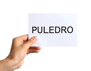 Hand holding a white paper note with the word "PULEDRO" printed on it