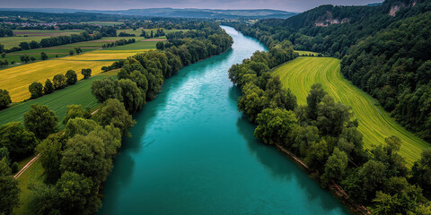 Aerial View of a Stunning Turquoise River Flowing Through Lush Green Forests and Farmland