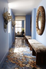 A light-filled hallway displays a unique, stone-like flooring composed of circular wood slices, complemented by calming blue walls and rustic-style seating.