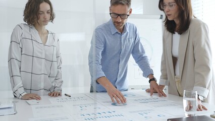 Business team analyzing financial data and discussing growth strategies during a productive meeting in a modern office. Business people concept