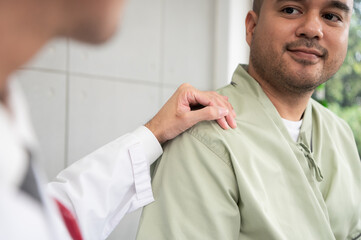 The doctor talks and encourages the patient about treatment options using a digital tablet, promoting clear communication and trust in a bright and supportive hospital environment.