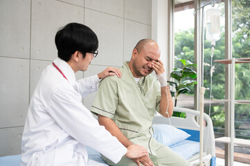 The doctor talks and encourages the patient about treatment options using a digital tablet, promoting clear communication and trust in a bright and supportive hospital environment.