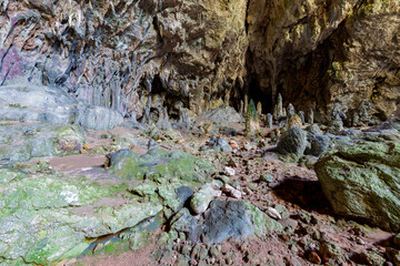 Nimara cave near Marmaris, Turkey inside. Stalactites stalagmites and streak formations in cave of Nimara Magarasi, Turkey. Stone walls and rocks in natural cave. stones covered with moss