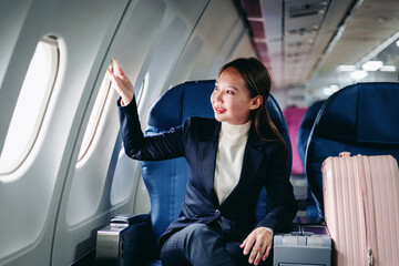 businesswoman traveling airplane corporate flight observing view contemplating journey future success comfortable passenger seat window