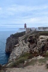  Cabo de S&atilde;o Vicente near Sagres, Algarve &mdash; the historic lighthouse perched on dramatic limestone cliffs overlooking the Atlantic Ocean. Golden-hour shot showing waves crashing into sea stacks and the