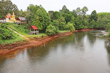 Prasaeng Canal in the light rain, surrounded with lush tropical forest, near Chiao Lan dam, in Surat Thani, Thailand
