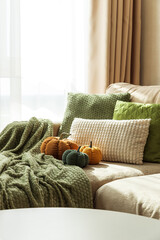 Cozy Autumn Sofa with Fabric Pumpkins and Textured Pillows