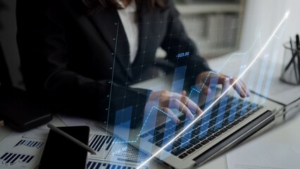 A business professional focuses on financial data with a laptop, incorporating graphical overlays to highlight growth trends and modern analytical technology. Copula