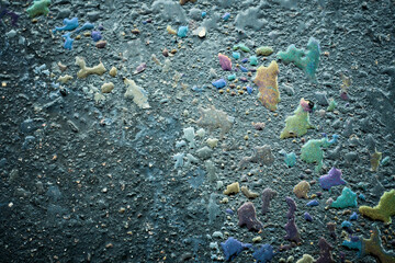 Iridescent oil slick creating abstract colorful pattern on asphalt