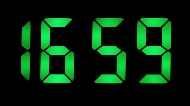 Digital clock with large green digits on black counting down seconds to 17:00.