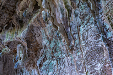 Nimara cave near Marmaris, Turkey inside. Stalactites stalagmites and streak formations in cave of Nimara Magarasi, Turkey. Stone walls and rocks in natural cave. stones covered with moss