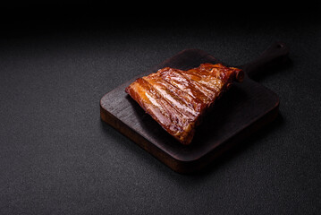 Grilled or barbecued pork or beef ribs with sauce. Cooked or smoked ribs
