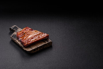 Grilled or barbecued pork or beef ribs with sauce. Cooked or smoked ribs