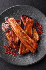 Grilled or barbecued pork or beef ribs with sauce. Cooked or smoked ribs