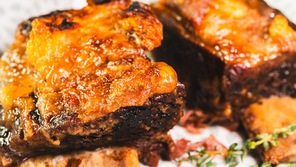 Tender, fall-off-the-bone braised beef short ribs, presented on a plate with fresh thyme. A rich, hearty, and deeply flavorful main course, perfect for comfort food imagery.