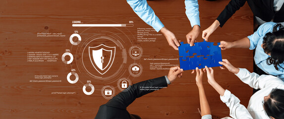 A diverse business team collaborates around a wooden table, piecing together a puzzle while digital...