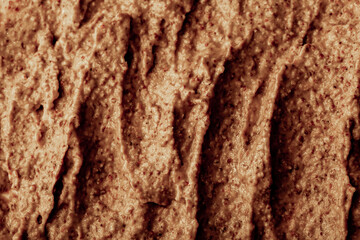 Chocolate ice cream with nuts and banana, texture. Chocolate smoothie cocktail close-up. Nut paste as a background.