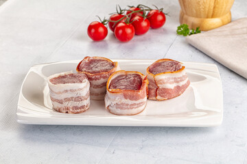 Raw pork tenferloin with bacon