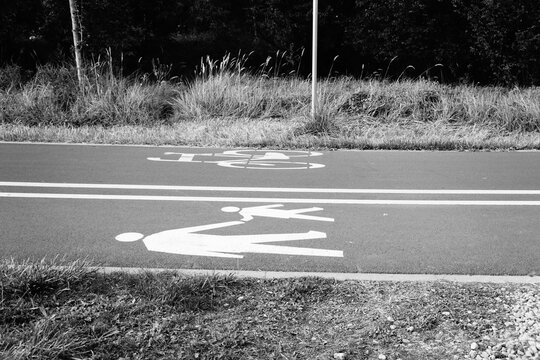 Shared path in black and white with clear white symbols for bicycles and walking, emphasizing efficient dedicated routes for non-motorized transport