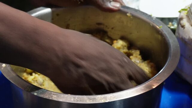 the preparation of the potato filling for panipuri or golgappe. The filling is made by mashing boiled potatoes and mixing them with other ingredients in a bowl.