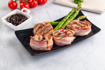 Tasty grilled pork medallion with bacon