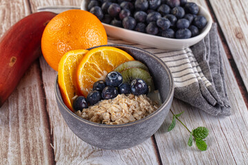 Oats porridge with blueberry, kiwi and orange