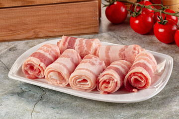 Raw bacon pork roll sliced