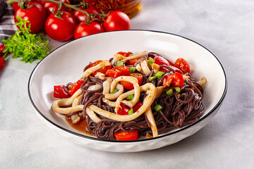 Black rice pasta with squid and tomato