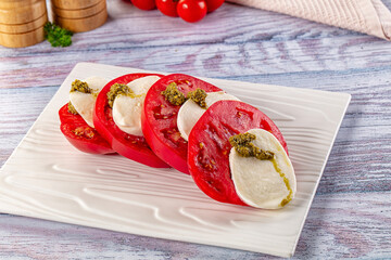 Italian Caprese salad with tomato, mozarella and pesto