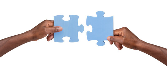 Man holding and matching two pieces of jigsaw puzzle, isolated on white or transparent background
