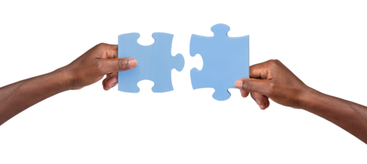 Man holding and matching two pieces of jigsaw puzzle, isolated on white or transparent background