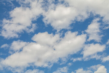 White clouds are shown against a blue sky.