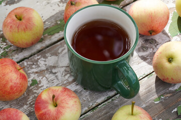 Warm apple cider mug with fresh harvest apples