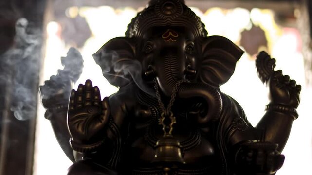 Mystical Silhouette of Lord Ganesha with Wafting Incense Smoke.