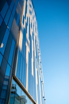 Glass skyscraper facade in Oslo Norway reflecting the blue sky, minimalist corporate identity background with clarity and copy space for branding and layouts