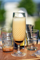 Iced coffee latte served in elegant glass on wooden table