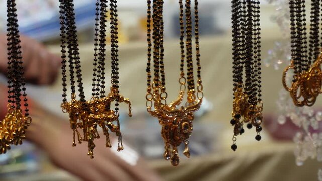 A display of traditional Indian black beads necklaces, also known as mangalsutra which are significant in Indian culture, symbolizing marital status and the bond between husband and wife
