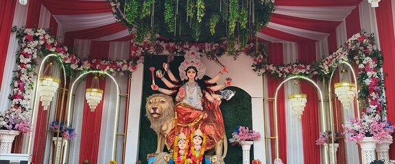 Idol of Goddess Devi Durga at a decorated puja pandal , Durga Puja is a famous and major religious traditional festival of Hinduism that is celebrated throughout the world.
