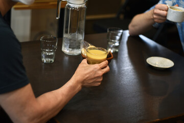 Friends drinking coffee together at cafe table