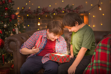 The boys open a Christmas gift. A magical light comes out of the box.