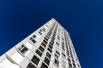 Fototapeta premium High-rise residential buildings with geometric forms and modernist architecture under deep blue clear sky