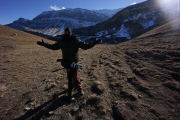 Happy Cameraman with Tripods in Snowy Caucasus Mountains, Winter Scene