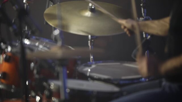 Montage of a musician intensely playing both a drum kit (cymbals) and bongo drums, highlighting dynamic percussion and rhythmic performance in a studio setting.